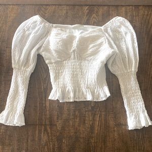 This is a stretchy, long-Sleeved, v-neck, white, cropped shirt